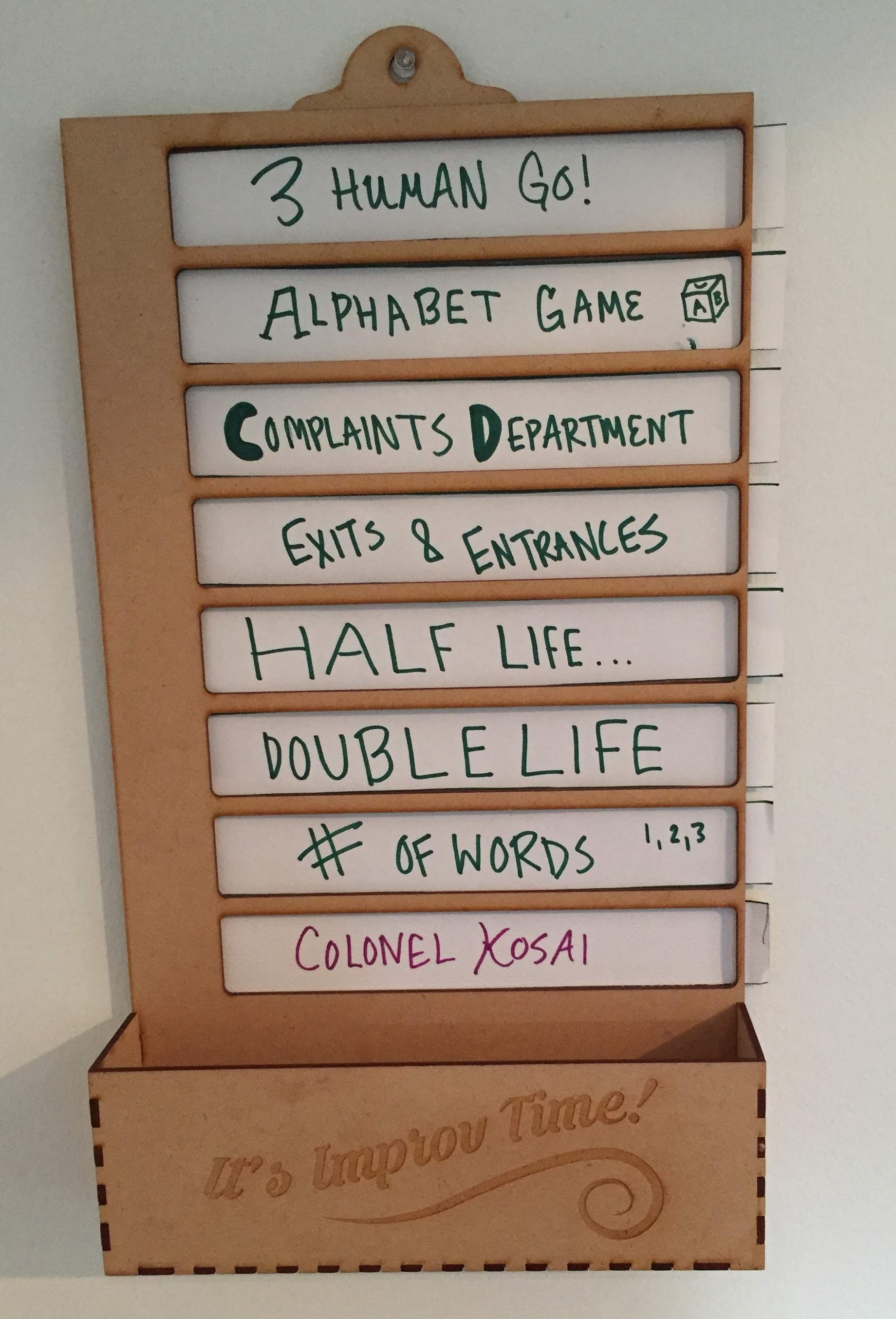 Laser-cut wooden holder of improv game name slips